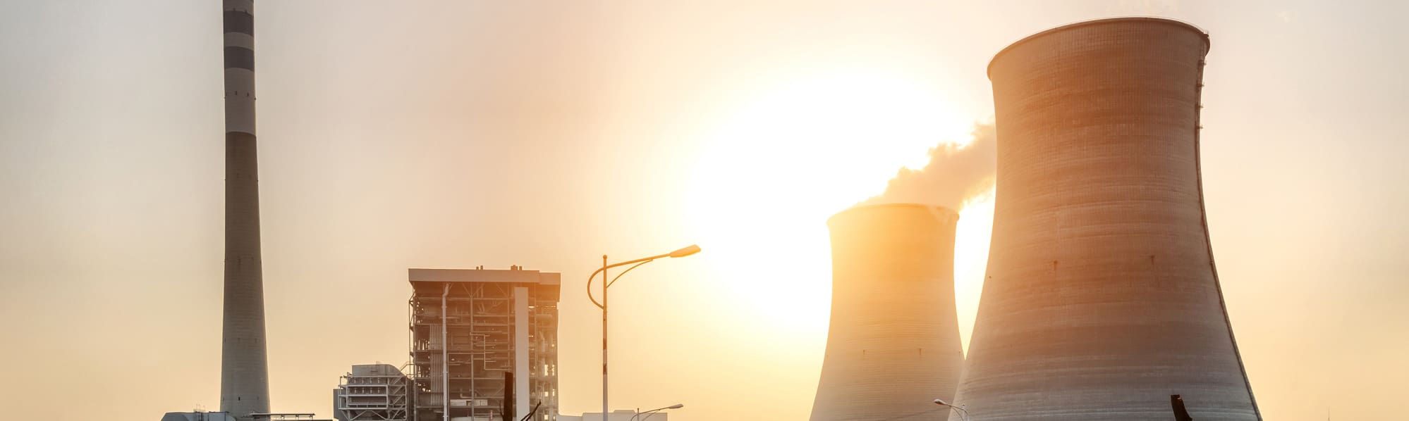 A picture of nuclear cooling towers with a sunset background